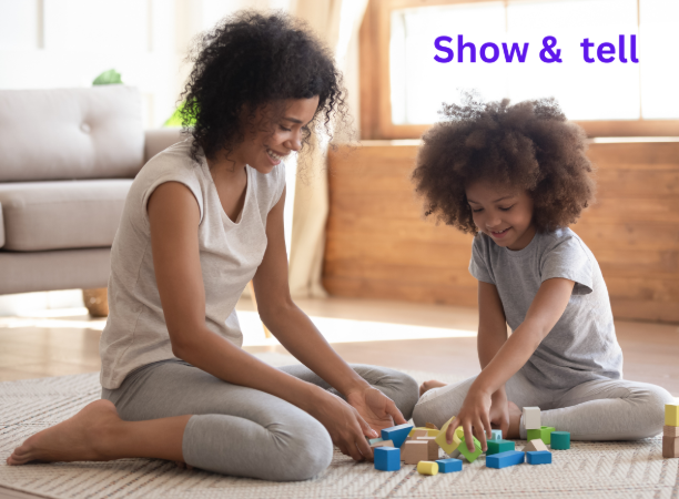 A mother and daughter playing with wooden blocks, captioned 'Show & tell'