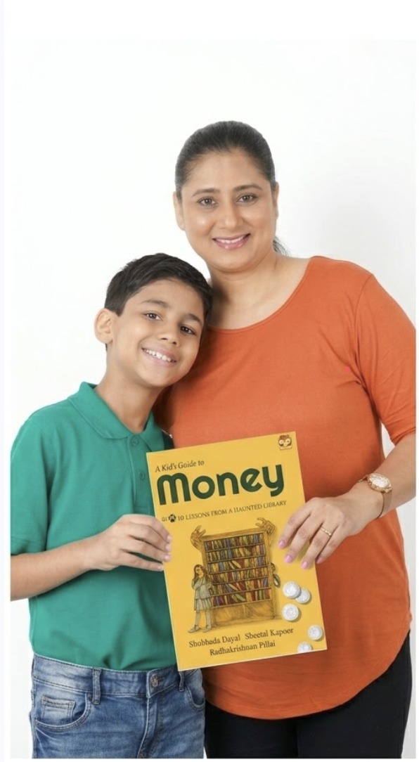A mother and son holding up the book 'A Kid's Guide to Money'